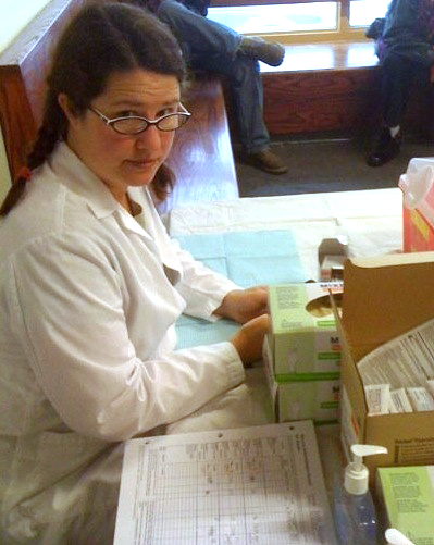 A nurse working with medical supplies